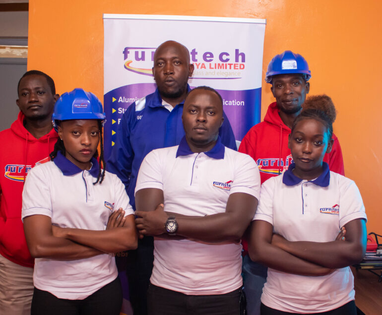 Furnitech's team posing for a photo inside the office.