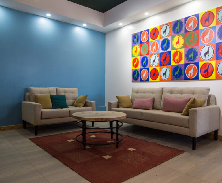 Art inside a waiting bay in an office in Kenya with different interior design finishes materials used to complement the room