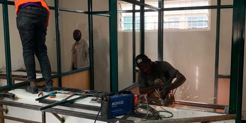 Men fixing aluminium partitioning